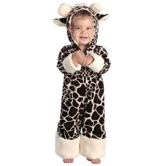 a little boy in a giraffe costume standing with his hands on his hips