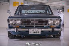 an old style car is parked in a garage with the license plate on it's hood