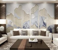 a living room with white couches and brown table in front of a wall mural