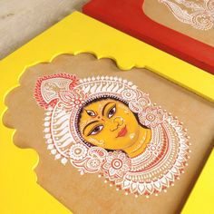 two wooden trays decorated with an image of a woman's face on them