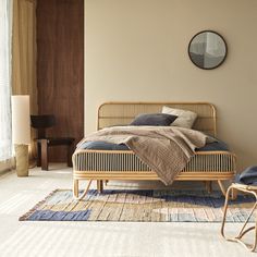 a bed sitting on top of a rug next to a window