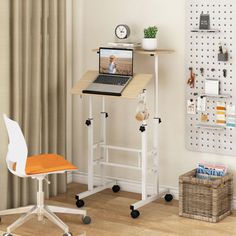 a laptop computer sitting on top of a wooden table next to a white desk chair