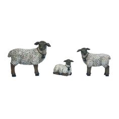 three sheep standing and laying next to each other on a white background with no one in the photo