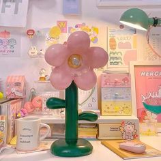 there is a pink flower that is on the desk