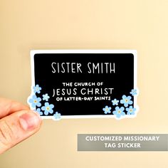 a person holding up a sticker that says sister smith the church of jesus christ