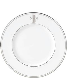 an empty white plate with silver trim on the edge and a black stripe down the middle