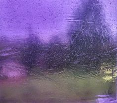 a close up view of the outside of a window with raindrops on it