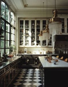 a kitchen with black and white checkered flooring, chandelier hanging from the ceiling