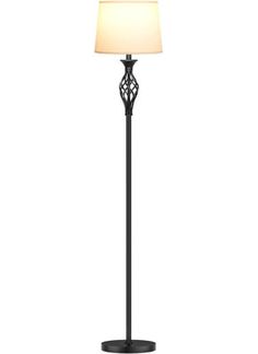 a black floor lamp with a white shade