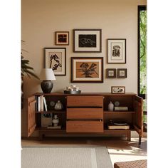 a living room filled with furniture and pictures on the wall