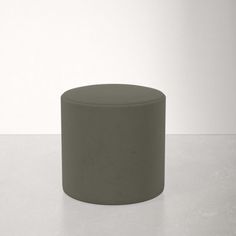 a grey stool sitting on top of a white floor