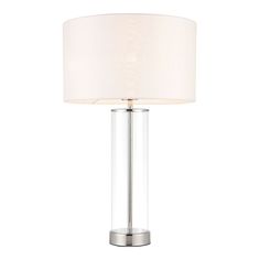 a table lamp with a white shade on it's side and a silver base