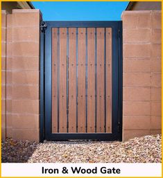 an iron and wood gate in front of a brick wall with the words iron & wood gate on it