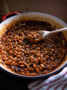 a pot filled with beans on top of a stove