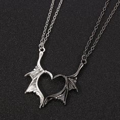 Elevate your love with the Dragon Wing Love Necklace, a symbol of unique and everlasting affection. Crafted with meticulous detail, this stunning piece features two intricately designed dragon wings, united in perfect harmony. Each wing is expertly crafted from premium quality metal and polished to a gleaming finish, creating a captivating and eye-catching accessory. The Dragon Wing Love Necklace is more than just jewelry; it's a statement of devotion and admiration. Whether you're expressing yo Demon Dragon, Dragon Wing, Necklace Couple, Bff Jewelry, Bracelet Viking, Friendship Necklace, Biker Jewelry, Dragon Necklace, Couple Necklaces