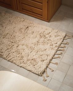 a bathroom with a rug on the floor