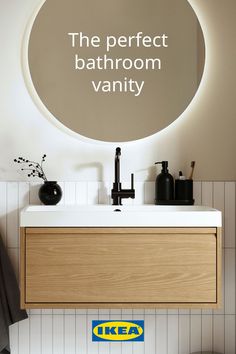 a bathroom vanity with a circular mirror above it and the words ikea on the wall