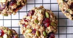 several cookies with nuts and cranberries on a cooling rack