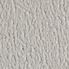 an up close view of the texture of a carpet with white fur on it and grey background