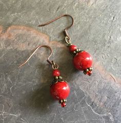 "These are pretty red coral earrings that will add a \"pop\" to many outfits.  The red coral earrings are not large, but red is a bright color to add interest to most attire. The brass is unusual with red, but I love the combination. The red earrings would be a nice gift. 3/4 inches" Coral Drop Earrings, Red Coral Earrings, Fun Bracelet, Purple Jewelry, Turquoise Heart, Coral Earrings, Red Jewelry, Coral Jewelry, Red Earrings