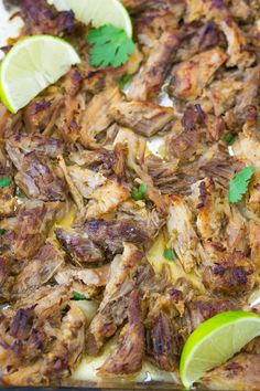 chicken with limes and cilantro on a baking sheet, ready to be cooked