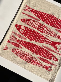 a piece of cloth with red fish on it