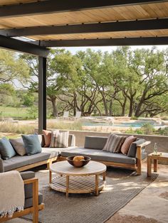 an outdoor living room with couches and tables