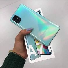 someone holding up their samsung note 9 in front of the camera with its finger on it