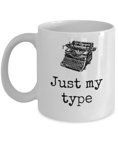 a white coffee mug with the words just my type on it and an old fashioned typewriter