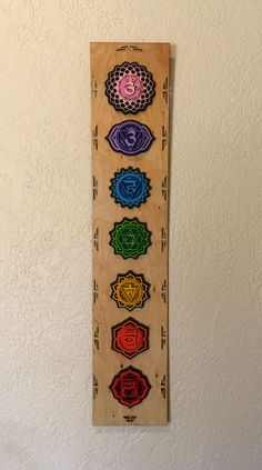 "This Chakra is made with 5 layers of 1/4\" birch plywood that is laser cut, hand painted, wood stained, glued then finished with a light clear coat. The color tone is Multi-colored according to each Chakra with a wood stained base. Each piece is a labor of love. I take great pride in making these Chakra's for you to enjoy. Many of these pieces find their way into homes, temples, shrines, altars, yoga and meditation spaces. Chakra Size: 35.5\" x 7\" x 1.25\" Chakra is Sanskrit for vortex, spinni Chakras Wall Art, Yoga And Meditation Space, Chakra Wall Hanging, Chakra Wall Art, Chakra Painting, Mandala Stencils