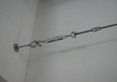 a close up of a metal object on the wall in a room with white walls