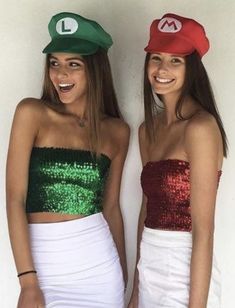 two women wearing mario hats and green sequins are standing next to each other