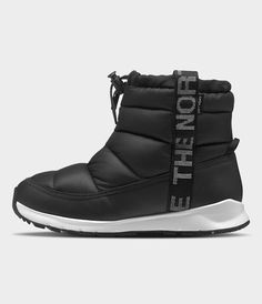 a pair of black and white snow boots with the words north written on the side