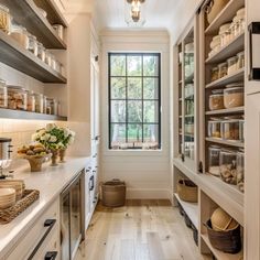 a kitchen filled with lots of open shelves