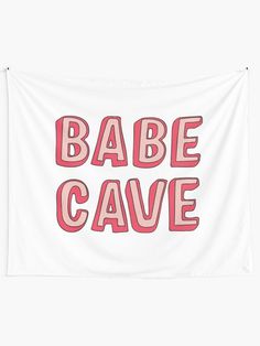 a white wall tapestry with the words babe cave in pink and red letters on it