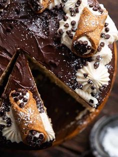 a chocolate cake with white frosting and chocolate chips