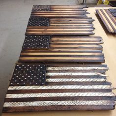 an american flag made out of wooden planks sitting on top of a table next to other pieces of wood