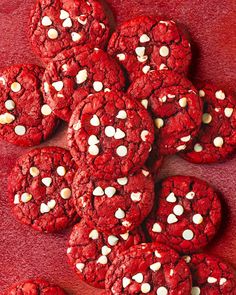 a pile of red velvet cookies with white chocolate chips