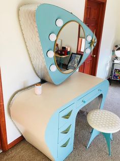 a blue and white desk with a mirror on it