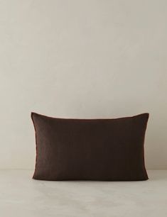 a brown pillow sitting on top of a white table