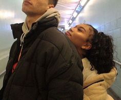 a man standing next to a woman on an escalator