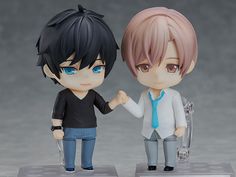 two anime figurines are standing next to each other, one is holding the hand of another