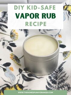 a tin of vapor rub sitting on top of a flowered table cloth with the words diy kid - safe vapor rub recipe