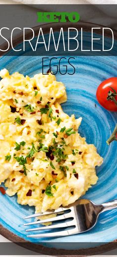 scrambled eggs on a blue plate with a fork and cherry tomatoes next to it,