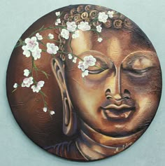 a painting of a buddha face with flowers on it