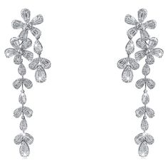 18k white gold star diamond earrings. Featuring a brilliant blend of round and baguette diamonds, these earrings offer a captivating sparkle from every angle. Perfect for special occasions or elevating your everyday style, they are designed to leave a lasting impression. Earring Information Gold Purity : 18K Color : White Gold Gold Weight : 21.32g Length : 2.85'' Diamond Count : 308 Round Diamonds Round Diamond Carat Weight : 2.20 ttcw Baguette Diamonds Count : 196 Baguette Diamonds Carat Weight Baguette Earrings, Baguette Earring, Diamond Baguette, Ringe Gold, American Modern, Baguette Diamonds, Gold Star, Baguette Diamond, High Jewelry