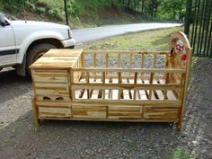 a bed frame made out of pallet wood with drawers on the bottom and side