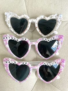 three heart shaped sunglasses with the words maton of honor and maid of honor written on them