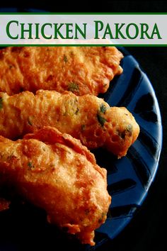 chicken pakora on a blue plate with green lettering