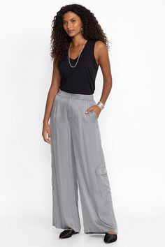 Crafted from a lightweight flowing fabric, the Cupro Pleated Pull On Pants add a stylish flare to a classic wide leg. Featuring an elastic waist and pleated detailing at the front, these wide-leg pants are finished with slant packets and cargo pockets for a unique twist. Pair with a fitted tank and sandals for a polished casual look. Women's Cupro Pleated Pull by Johnny Was in Cloudburst, Size Large Polished Casual, Flowing Fabric, Boho Chic Outfits, Women's Blouses, Chic Outfit, Embroidered Jeans, Bottom Clothes, Johnny Was, Pull On Pants